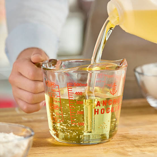 Pouring oil into Anchor Hocking glass measuring cup